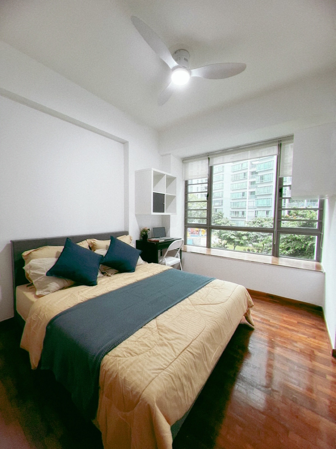 Room 802 — bedroom with large window overlooking neighbouring blocks