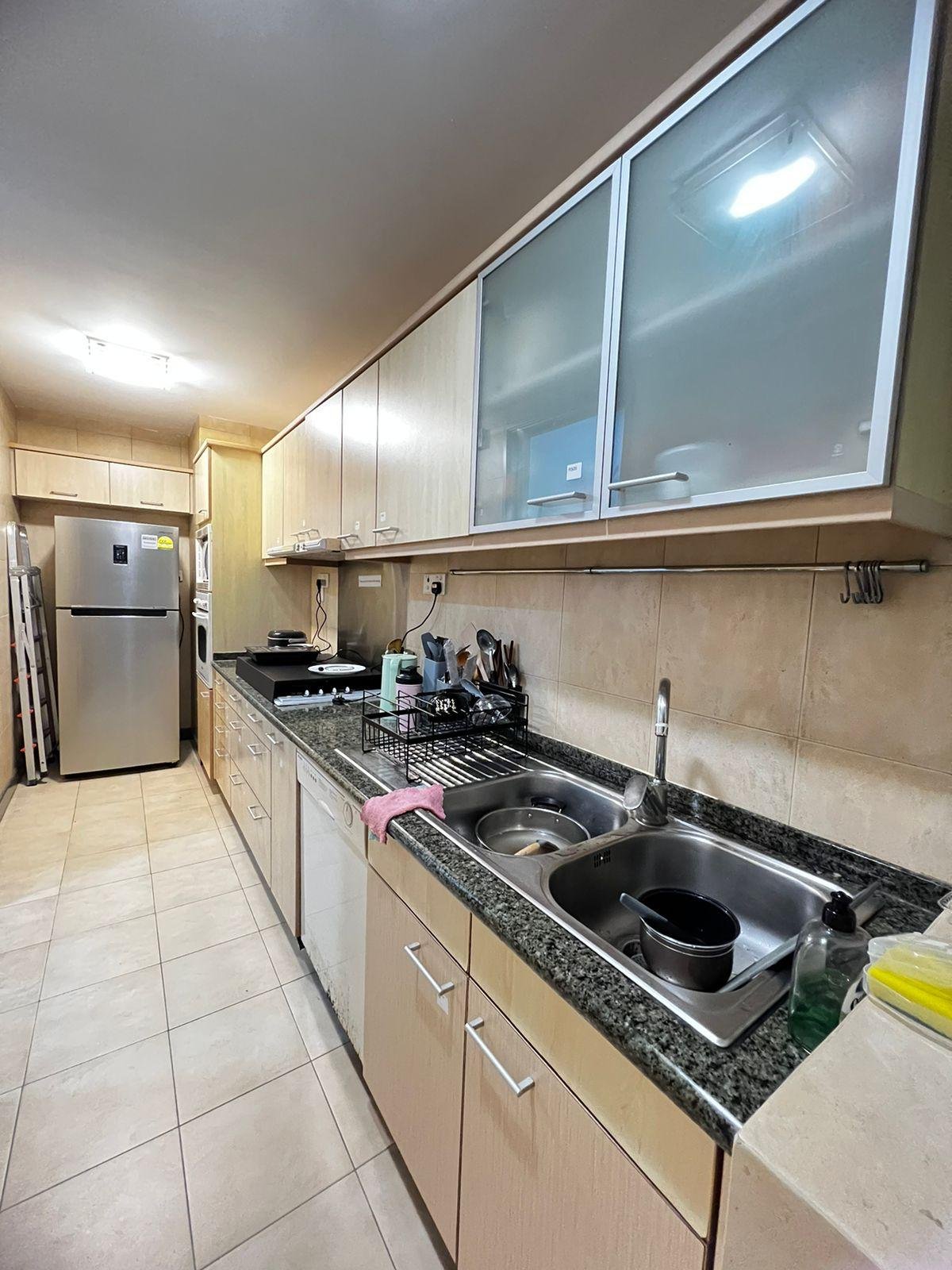Kitchen with granite worktop and refrigerator at The Tessarina
