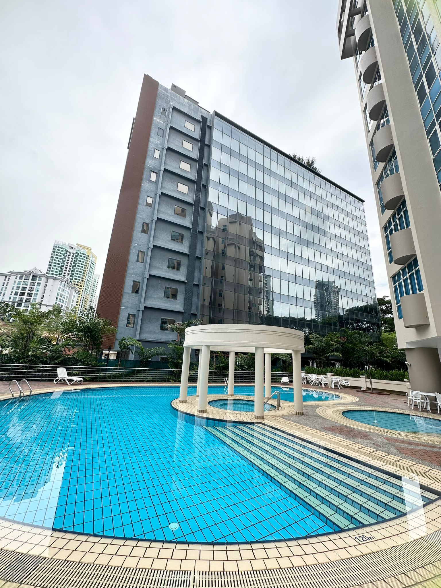 Harvest Mansions condominium — pool pavilion against the city skyline