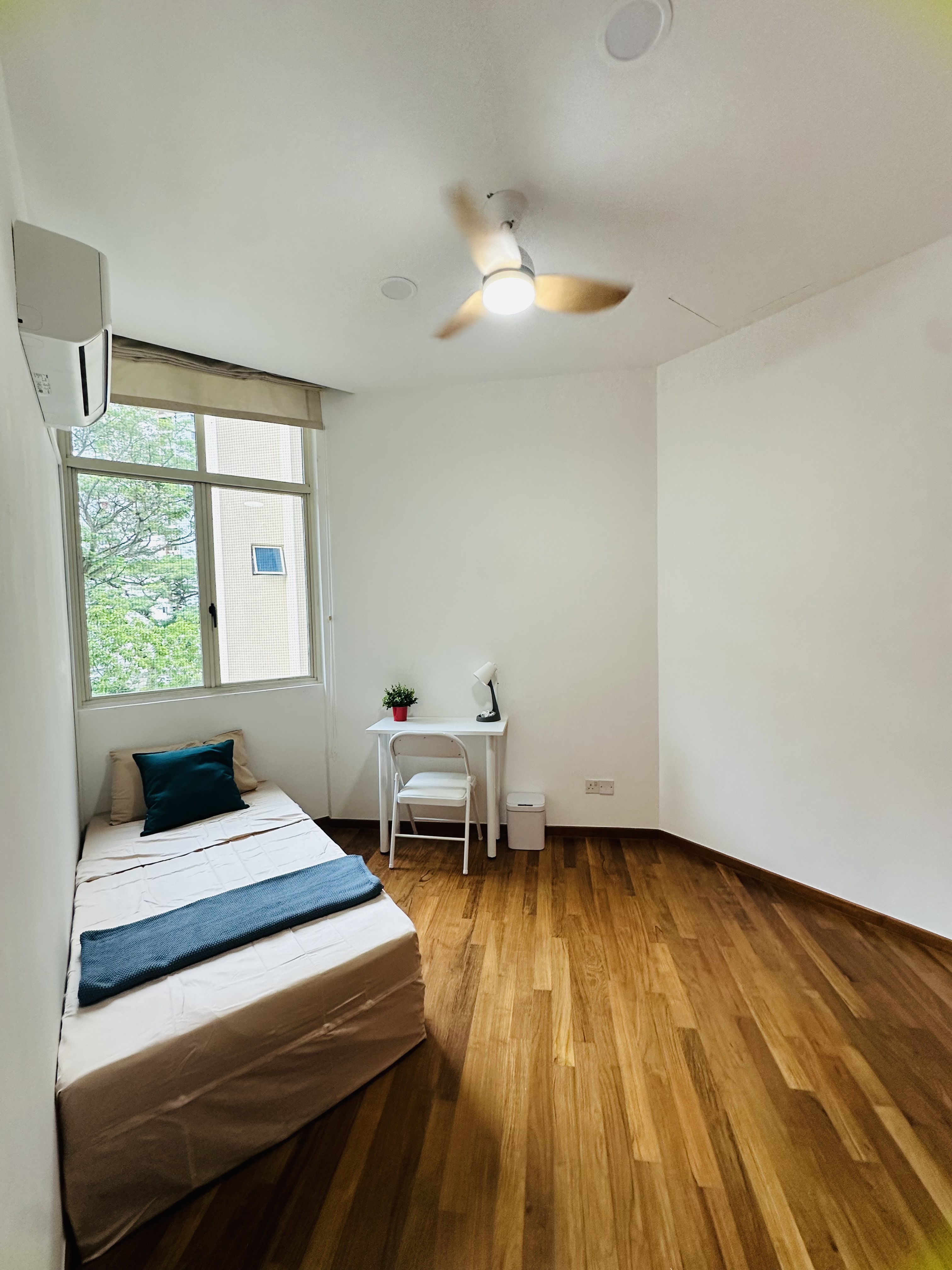 Room 306 at Harvest Mansions — bed with wardrobe, air-conditioner and window