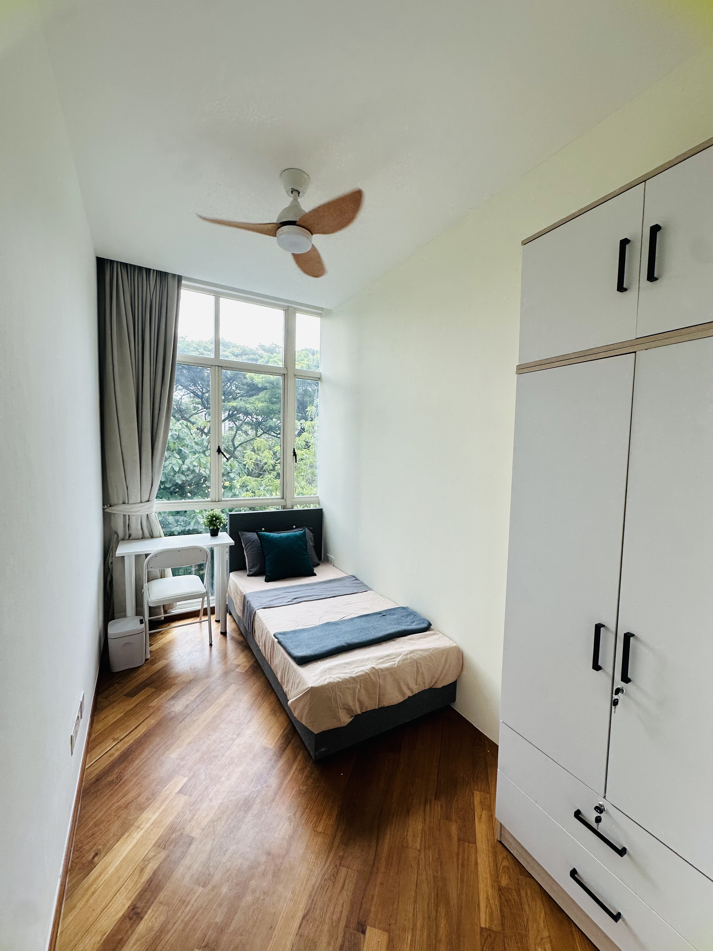 Room 303 at Harvest Mansions — bed with wardrobe and window