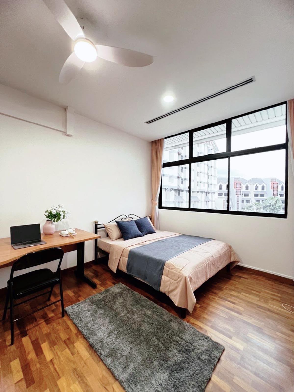 Room 702 — bed by the large window with study desk