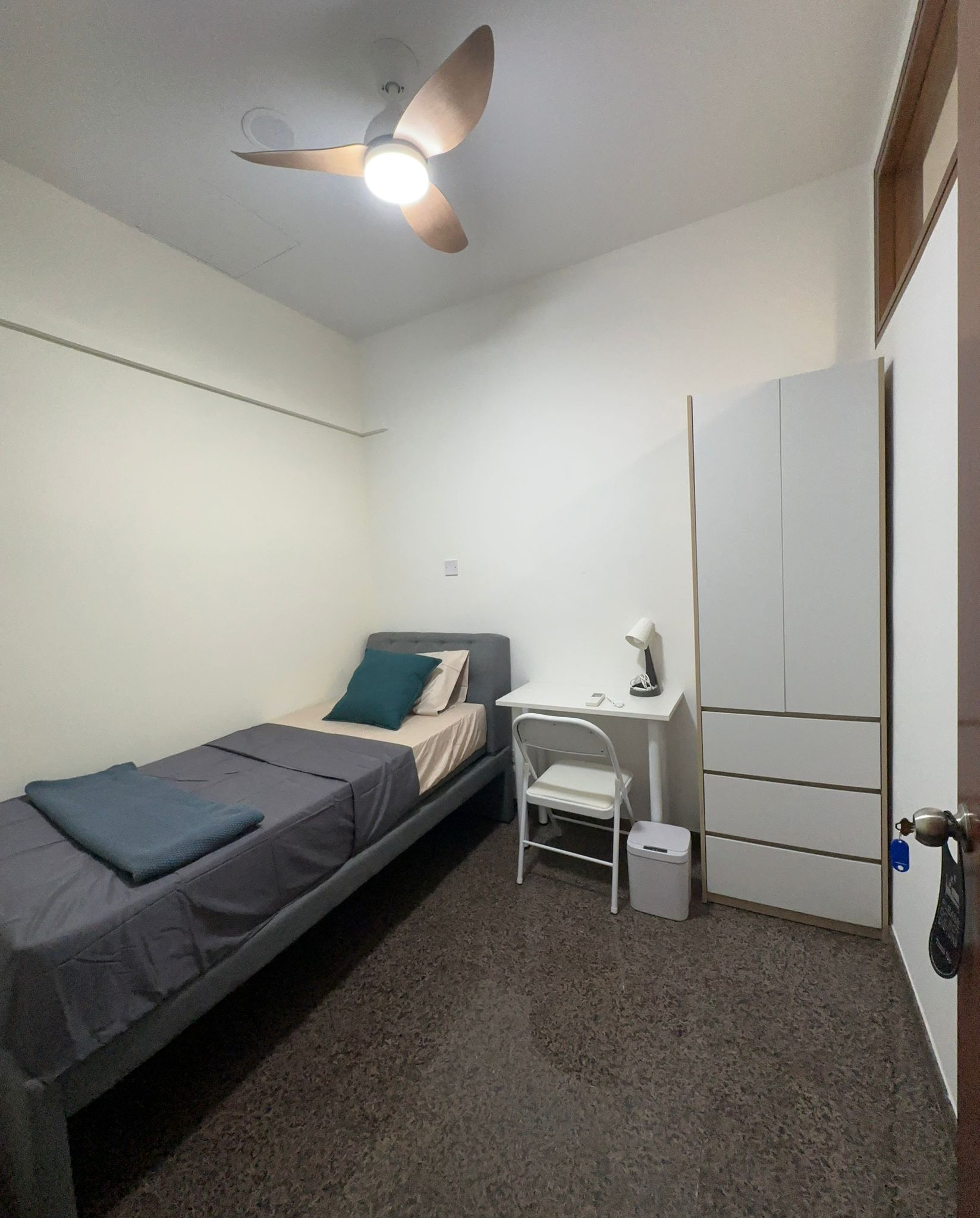 Room 300 at Harvest Mansions — bed with desk, wardrobe and window