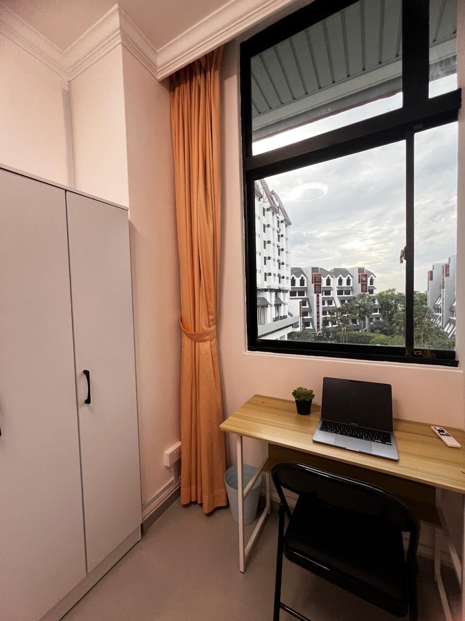Room 700 — study desk by the window with a view of the neighbourhood