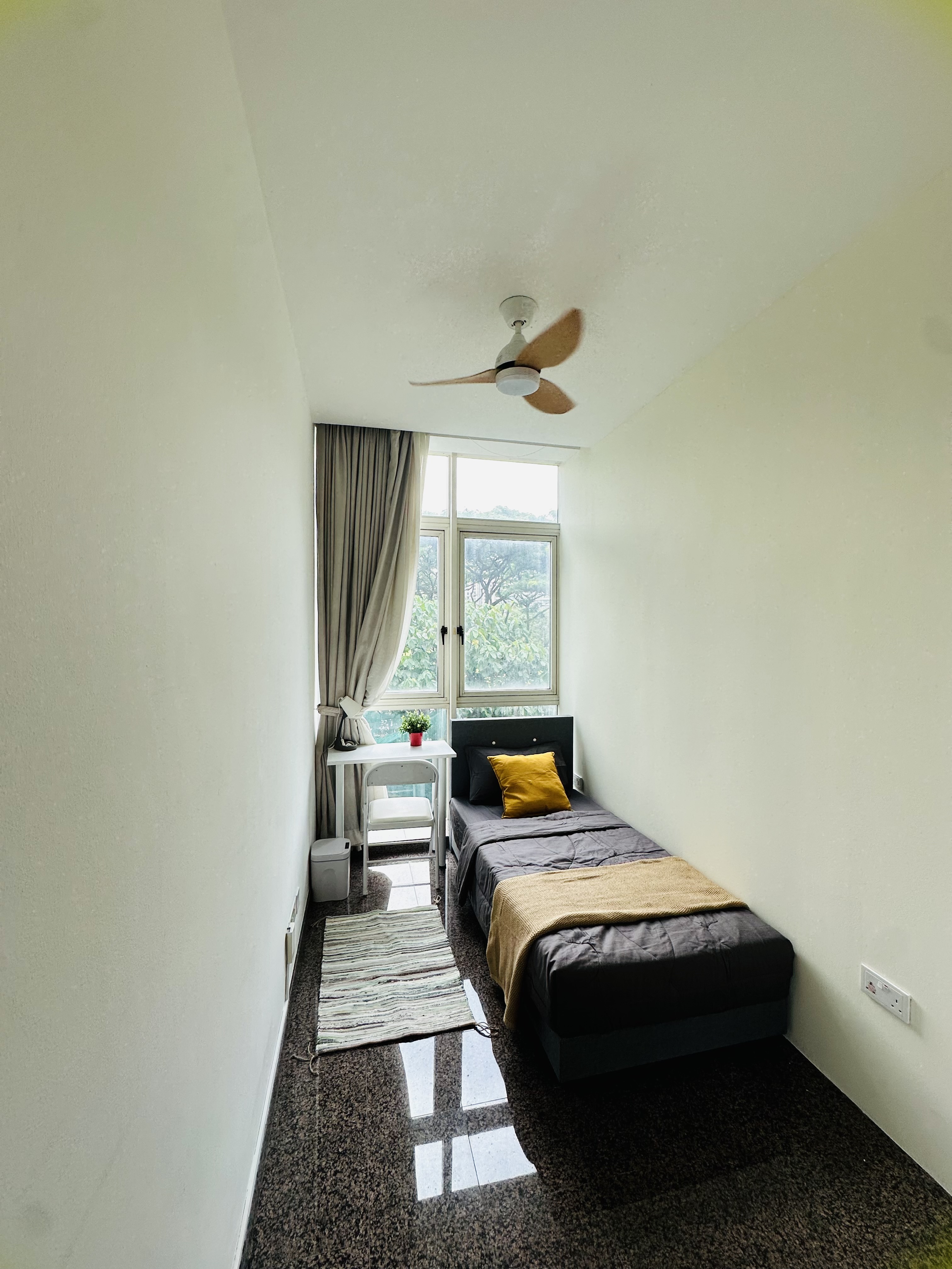Room 301 at Harvest Mansions — bed beside the window